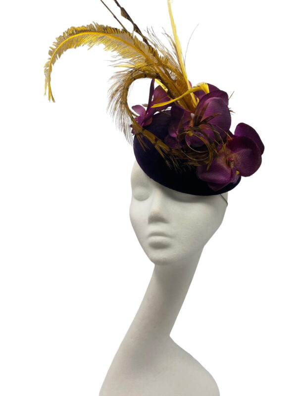 Deep purple velvet headpiece with an array of feather detail and mustard feathers to finish.